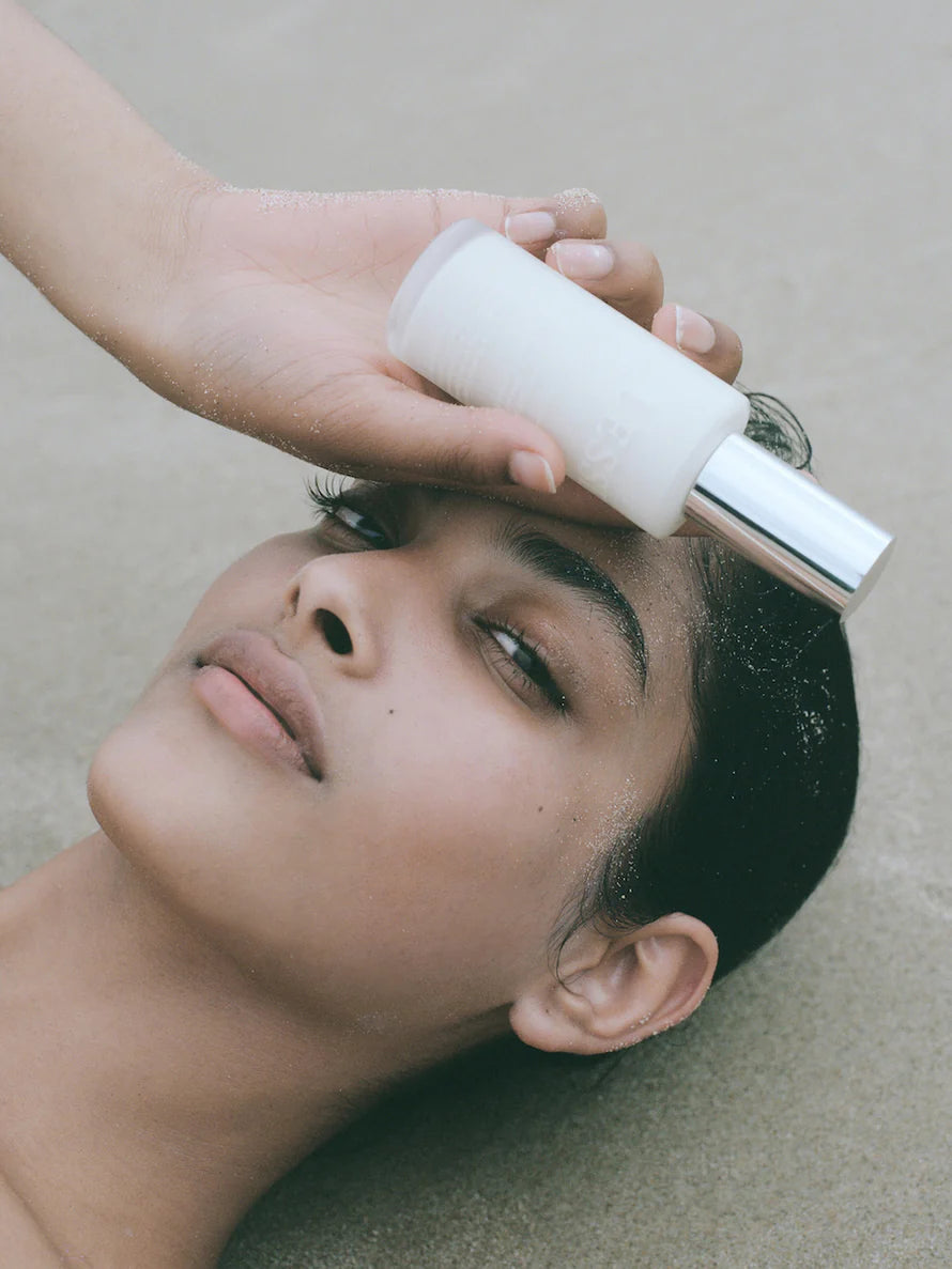Every Tone SPF Sunscreen from LESSE, woman holding bottle in her hand