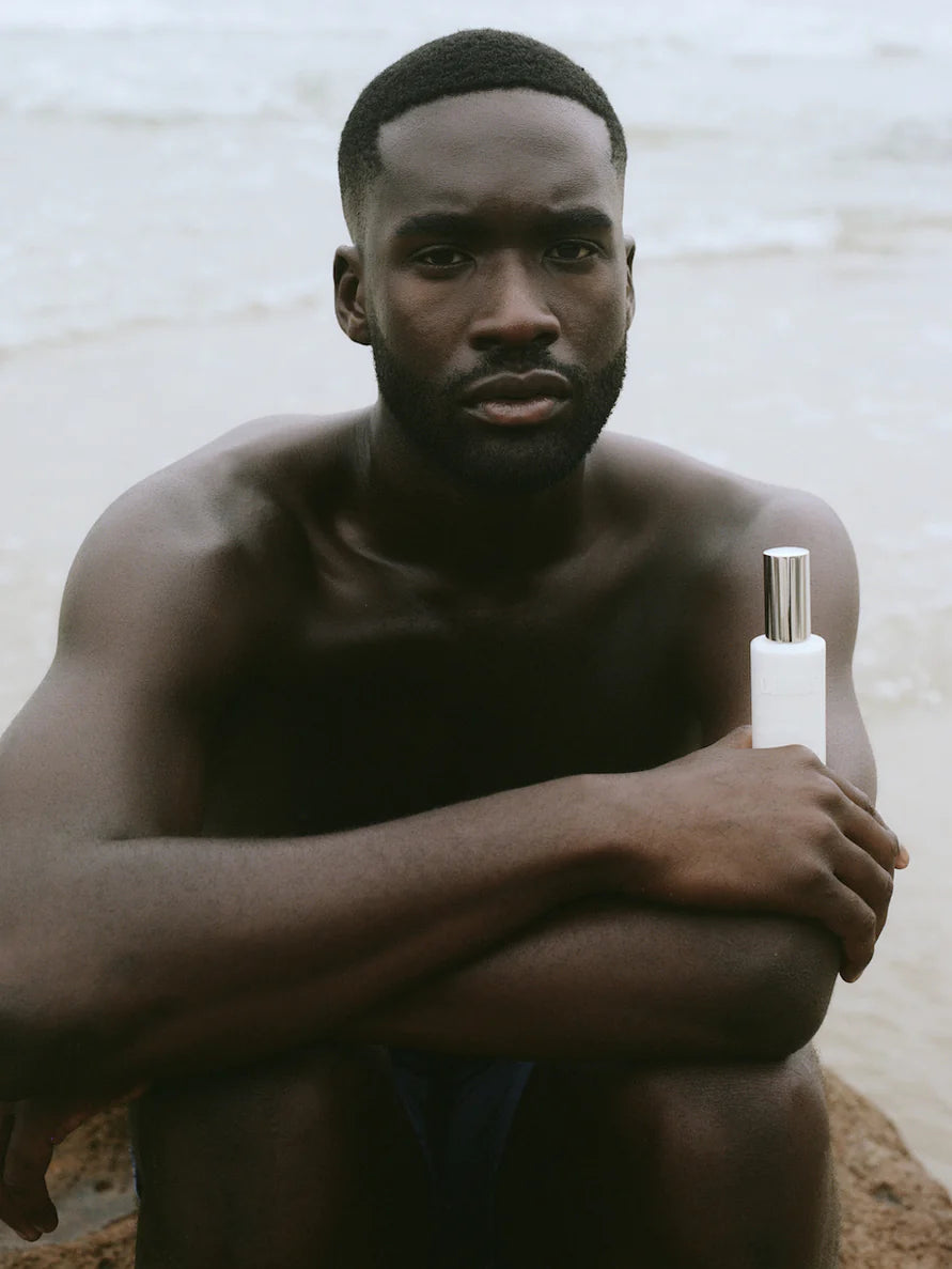 Every Tone SPF Sunscreen from LESSE, man holding the bottle in his hand