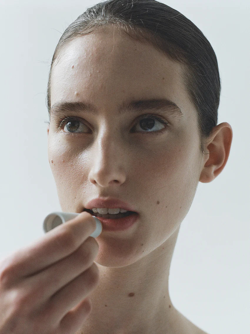 Soothing Lip Balm from LESSE, woman applying on lips
