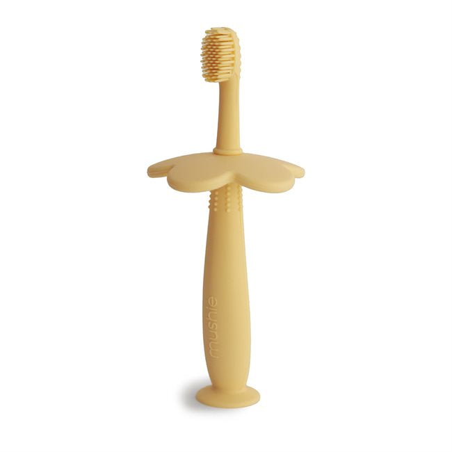 Flower training toothbrush from Mushie in color pale daffodil