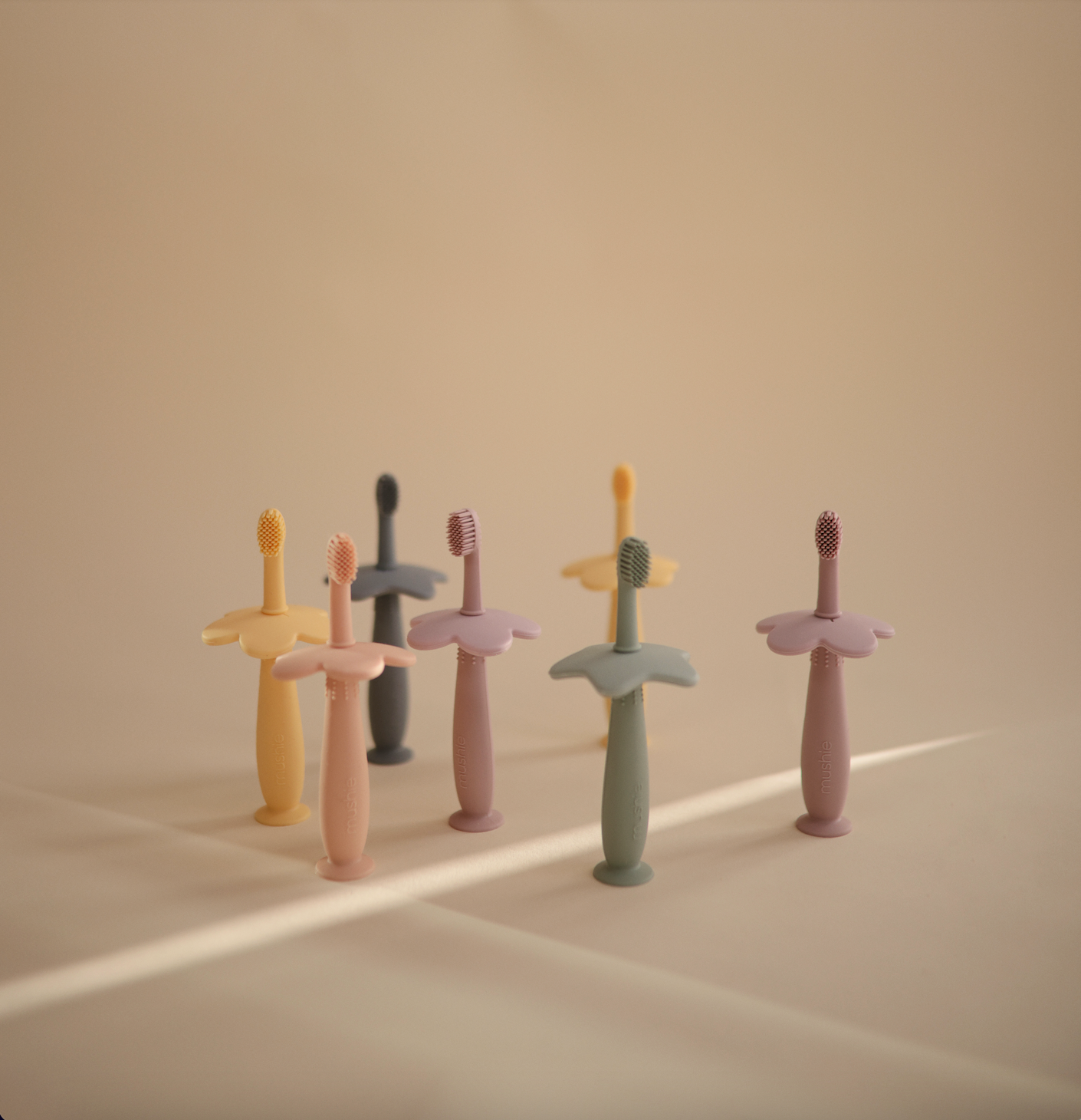 Flower training toothbrushes from mushie in different colors