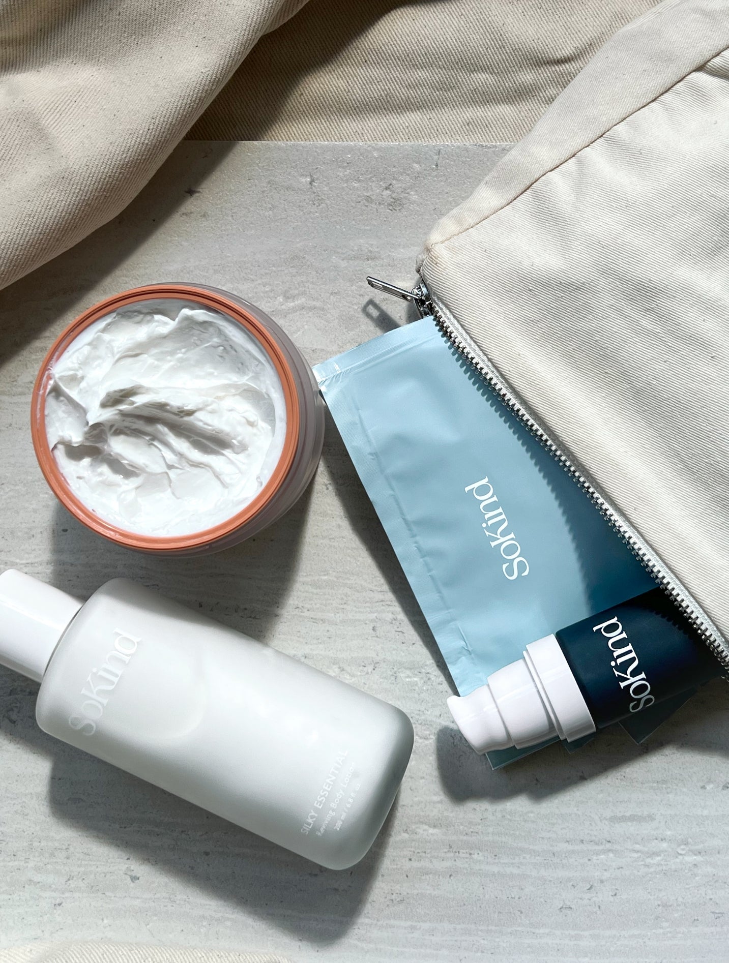 Pregnancy skin care kit from SoKind, includes four products and a toiletry pouch