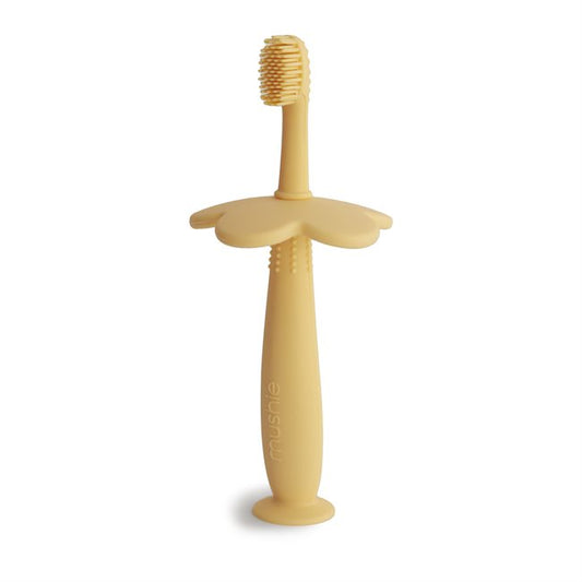 Flower training toothbrush from Mushie in color pale daffodil