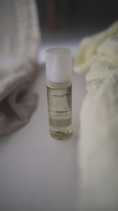 baby oil fragrance free from Mushie, video when a mother applying the oil on a baby